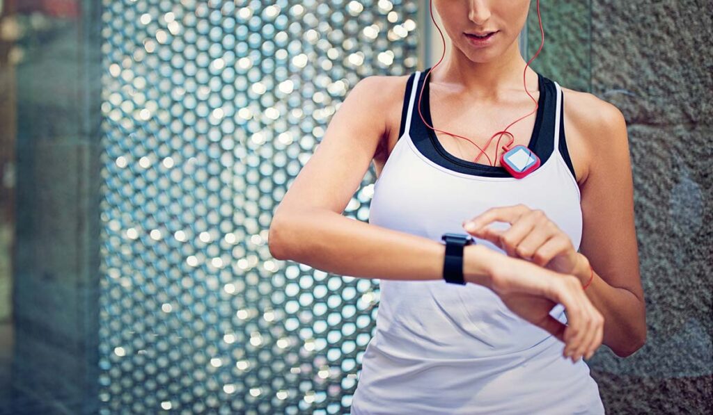 Woman checking her smart watch after excercising.